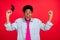 Photo of young afro guy gamer happy positive smile rejoice victory success isolated over red color background