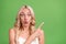 Photo of young amazed crazy girl stare haze point finger copyspace advertise product isolated on green color background