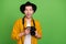 Photo of young amazed excited smiling man photographer take amazing picture isolated on green color background