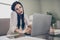 Photo of young anxious lady hold telephone nervous argument typing laptop wear glasses shirt in home workstation indoors