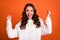 Photo of young attractive girl rejoice success fists hands hooray winner isolated over orange color background