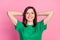 Photo of young attractive lady wear green t-shirt hands hold head freelancer chill time isolated on pink color