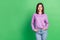 Photo of young attractive optimistic perfect lady hold hands in denim pockets stand empty space isolated on green color