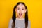 Photo of young attractive school girl amazed shocked surprised fake novelty  over yellow color background