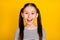 Photo of young attractive school girl happy positive toothy smile  over yellow color background