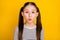 Photo of young attractive school girl pouted lips send air kiss  over yellow color background