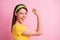 Photo of young attractive smiling crazy excited woman feminism raise fist up girl power isolated on pink color