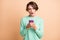 Photo of young attractive woman astonished shocked fake news novelty use cellphone isolated over pastel color background