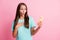 Photo of young beautiful amazed surprised woman use phone sees shocking comment post isolated on pink color background