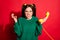 Photo of young beautiful angry furious girl hold yellow telephone after argument isolated on red color background