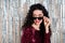 Photo of young beautiful happy cheerful flirty coquettish woman in sunglasses look copyspace isolated on shiny