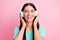 Photo of young beautiful happy excited positive smiling girl listen music in headphones isolated on pink color