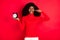 Photo of young black woman ignore avoid hold clock alarm close ear finger loud noise isolated over red color background