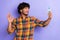 Photo of young blogging man popular instagram vlogger selfie recording video shooting palm greetings isolated on violet