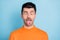 Photo of young brown hair man fooling grimacing joke humor comic tongue-out isolated over blue color background