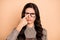 Photo of young brown hair woman unhappy sad upset finger touch eyeglasses displeased isolated over beige color