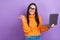 Photo of young business office worker woman wear orange jumper direct finger look empty space hold laptop offer isolated