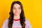 Photo of young charming lovely positive smiling dreamy curious girl look copyspace  on yellow color background