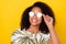 Photo of young cheerful african woman eyewear look empty space isolated over yellow color background