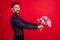 Photo of young cheerful gentleman give bouquet in copyspace boyfriend on date isolated on red color background