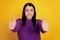 Photo of young cheerful girl happy positive smile show thumb-up like perfect fine advert isolated over yellow color