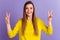 Photo of young cheerful girl show fingers peace cool v-symbol travel isolated over purple color background