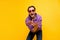 Photo of young cheerful man happy positive smile party hipster dance isolated over yellow color background