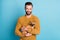 Photo of young cheerful positive smiling good mood man holding doggie chiahuahua isolated on blue color background