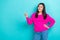 Photo of young cheerful pretty woman wear pink pullover look pointing finger mockup opening new cocktail bar isolated on