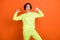 Photo of young cheerful young cool woman point fingers myself winner proud isolated on orange color background