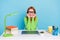 Photo of young clever lady work from home wear spectacles green sweater isolated on blue color background