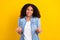 Photo of young clueless dark skin happy woman shrug shoulder clueless hands isolated on yellow color background