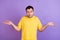 Photo of young clueless ignorant man shrug shoulders no idea puzzled isolated on purple color background