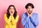 Photo of young couple happy positive smile amazed shocked fake novelty news isolated over pink color background