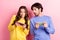 Photo of young couple worried nervous race speed game play smartphone isolated over pink color background