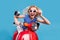 Photo of young excited girl happy positive smile drive motorbike fly wind hand touch sunglass isolated over blue color