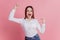 Photo of young excited girl rejoice victory fists hands scream success hooray isolated over pink color background