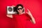 Photo of young excited man show rock sign metal music retro boombox audio isolated over red color background