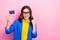 Photo of young excited promoter lady business costume nice glasses plastic card finger direct empty space offer isolated