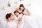 Photo of young family lady guy little girl mommy daddy daughter lying sheets under white blanket good mood spend time