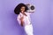Photo of young funky funny crazy african woman with boombox on shoulder show rock sign isolated on purple color