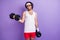 Photo of young funky funny serious man with hair and glasses hold dumbbells exercise isolated on purple color background