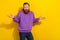 Photo of young ginger man in purple hoodie shrug shoulders don't know feel uncertain isolated on yellow color