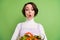 Photo of young girl amazed shocked look salad dieting weight loss vegetarian isolated over green color background