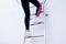 Photo of young girl climbing on ladder step by step