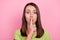 Photo of young girl finger touch lips conspiracy shh keep silence secret isolated over pink color background