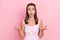 Photo of young girl unhappy sad upset negative moody confused displeased isolated over pink color background