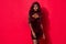 Photo of young gorgeous afro woman wear velvet dress charming elegant  over red color background