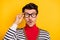 Photo of young guy amazed shocked surprised fake novelty news hand touch glasses isolated over yellow color background