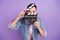 Photo of young guy close cover face clapboard look scene cut make movie producer isolated over purple color background